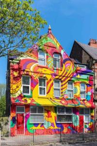 a colorful house with a painting on the side of it at 5 Sleeper LFC Themed Apartment in Liverpool