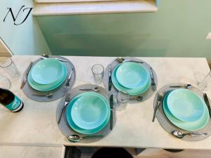 a table with four plates and glasses on it at NJ Luxury rooms and suites in Varna City