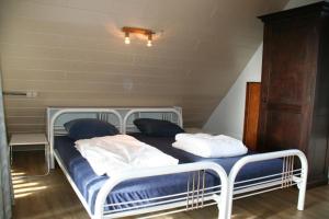 a bed with two pillows on it in a room at De Vlier 23 in Nieuwvliet