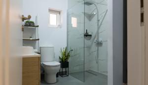 a bathroom with a toilet and a glass shower at Hill Apartment Cluj-Napoca in Cluj-Napoca