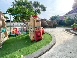 a group of playground equipment in a yard at CBG INN RedPartner near Stasiun Solo Balapan in Kadiporo