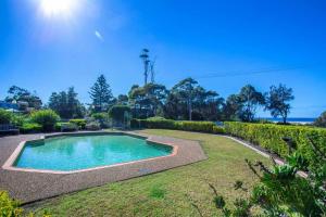 a swimming pool in the middle of a yard at Perfectly Positioned Across From Mollymook Beach in Mollymook