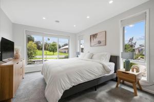 Un dormitorio blanco con una cama y una ventana grande. en Salt Breeze, en Cowes