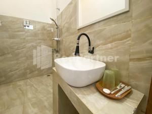 a bathroom with a white sink and a mirror at CBG INN RedPartner near Stasiun Solo Balapan in Kadiporo +51 photos