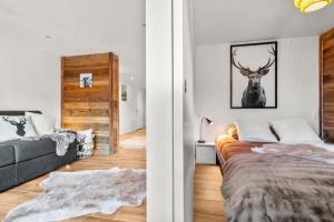 a bedroom with a bed and a deer picture on the wall at Magnifique appartement rénové in Saas-Fee
