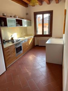 a kitchen with a tile floor with a stove top oven at Casa delle Rose - Appartamento Dagape in Marostica +15 photos
