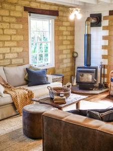 a living room with a couch and a stove at Petana Farm Stay in Morton