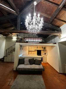 a living room with a couch and a chandelier at CHARME in Civita Castellana