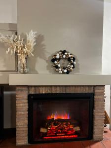 a fireplace in a living room with a mantle at CHARME in Civita Castellana