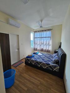 a bedroom with a bed and a large window at Valerie Homestay in Sandakan