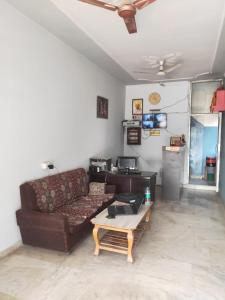 a living room with a couch and a coffee table at HOTEL CASTLE HOME STAY in Jaipur