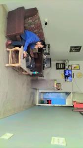 a person sitting on a chair in a room at HOTEL CASTLE HOME STAY in Jaipur