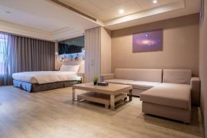 Postel nebo postele na pokoji v ubytování Guide Hotel Taichung Ziyou