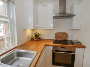 a kitchen with a sink and a stove at 7A Lansdown Place Lane in Cheltenham