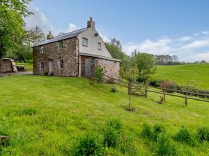 an old stone house on a green field at 2 Bed in Chepstow 42837 in Wolves Newton