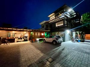 a car parked outside of a house at night at Pousada Ilha do Campeche in Florianópolis