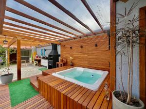 a hot tub sitting on a wooden deck at Pousada Ilha do Campeche in Florianópolis