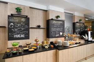 a bakery counter with a buffet of food at Hotel Bristol Budapest in Budapest