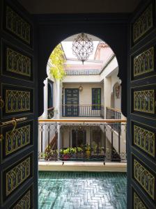 an open door to a house with a balcony at Riad Atrium & Spa in Marrakesh