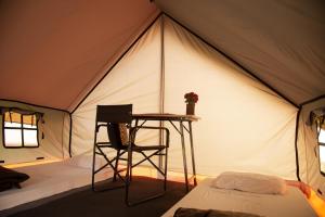 a tent with a table and a chair in it at Omak Tiger Seven in Sawāi Mādhopur