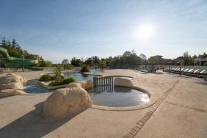 a water park with a water slide and a playground at Camping le Lac de Thoux in Saint-Cricq