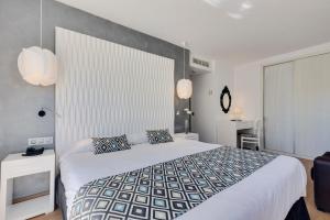 a bedroom with a large bed in a room at Cala Millor Garden Hotel - Adults Only in Cala Millor
