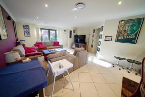 a living room with a couch and a table at Quay Largo in Lake Tabourie