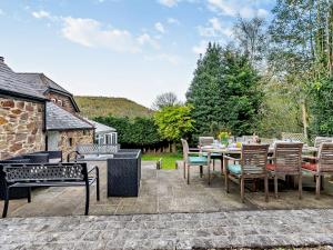 a patio with a table and chairs and a grill at 4 bed in Cromford 52094 in Highpeak Junction