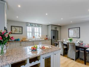 a kitchen with a island with a bowl of fruit on it at 2 Bed in Pilsbury SKN28 in Earl Sterndale