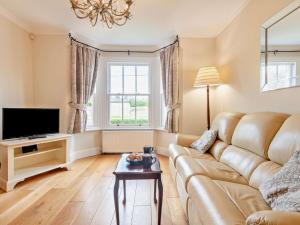 a living room with a couch and a tv at 3 Bed in Gillingham 53854 in Gillingham