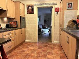 a kitchen with a door leading to a living room at 1 Bed in Gilwern 52882 in Gilwern