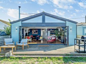 a blue shed with chairs and tables on a deck at 2 Bed in Whitstable WCC19 in Whitstable