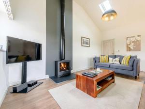 a living room with a couch and a fireplace at 2 Bed in Winchcombe 57828 in Winchcombe