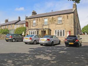 a group of cars parked in front of a building at 1 Bed in Nr Hexham CN196 in Wall