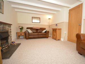 a living room with a couch and a fireplace at 1 Bed in Porthgain 61170 in Porthgain