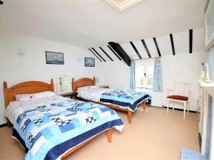 a bedroom with two beds and a window at 3 bed property in Mundesley KT043 in Mundesley