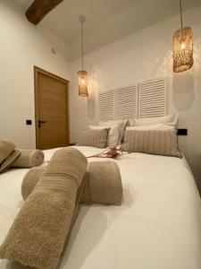 a large white bedroom with a large bed with two pillows at Charme & authenticité AU COEUR de la vieille Ville in Antibes