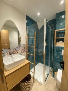 a bathroom with a sink and a shower at Charme & authenticité AU COEUR de la vieille Ville in Antibes