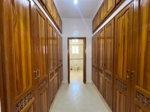 a hallway with wooden doors and a toilet in a bathroom at الطابق الأول لفيلا مجهز بامتياز in Fez