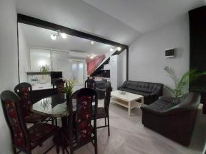 a living room with a table and a dining room at Merter Apartments in Kavadarci