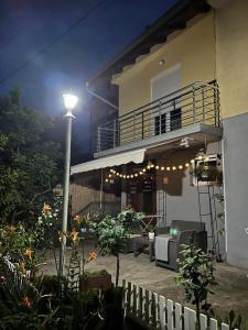 a house with a street light and a balcony at night at Smeštaj Filipović in Soko Banja