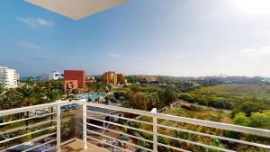 a balcony with a view of a city at Cala Millor Garden Hotel - Adults Only in Cala Millor