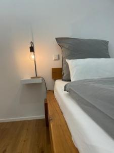a bedroom with a bed with a lamp on it at Haus 11 in Oberkirch