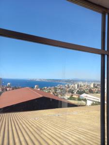 a view of a city from a window at Apartamento por dia in Viña del Mar