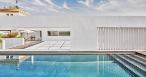 an image of a swimming pool in a house at Hotel Mercer Sevilla in Seville