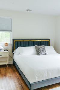 1 dormitorio con 1 cama grande con sábanas blancas y ventana en The Farm at Glenwood Mountain, 
