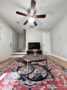 a living room with a ceiling fan and a table at Modern 2-story apt w/ high speed Wi-Fi & Patio! in Charlotte