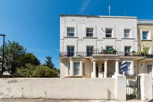 a white building with balconies on a white wall at Spacious Maida Vale 2 Bed Apartment in London