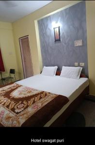 a bedroom with a large bed in a room at Hotel Swagat in Puri