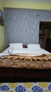 a bedroom with a large bed with a bow on it at Hotel Swagat in Puri